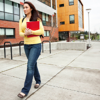 Woman walking on community college campus 1x1 CROP